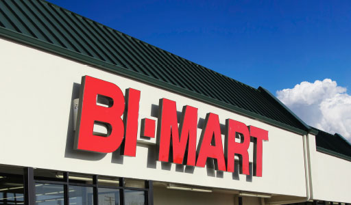 Bi-Mart store exterior featuring garden center with potted plants