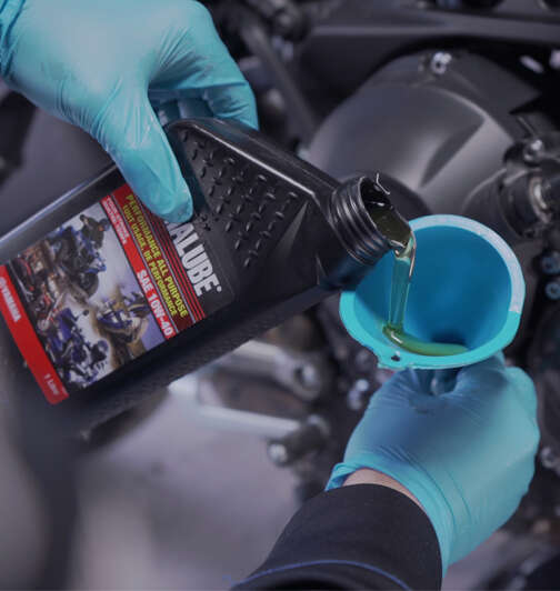 Yamalube oil pouring into engine